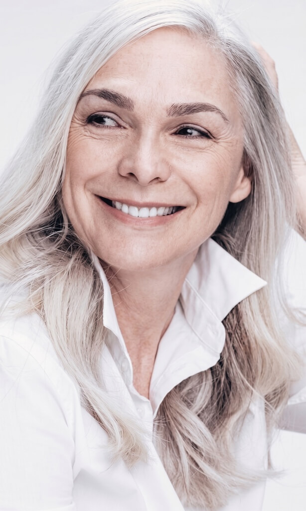 Smiling woman with long grey hair