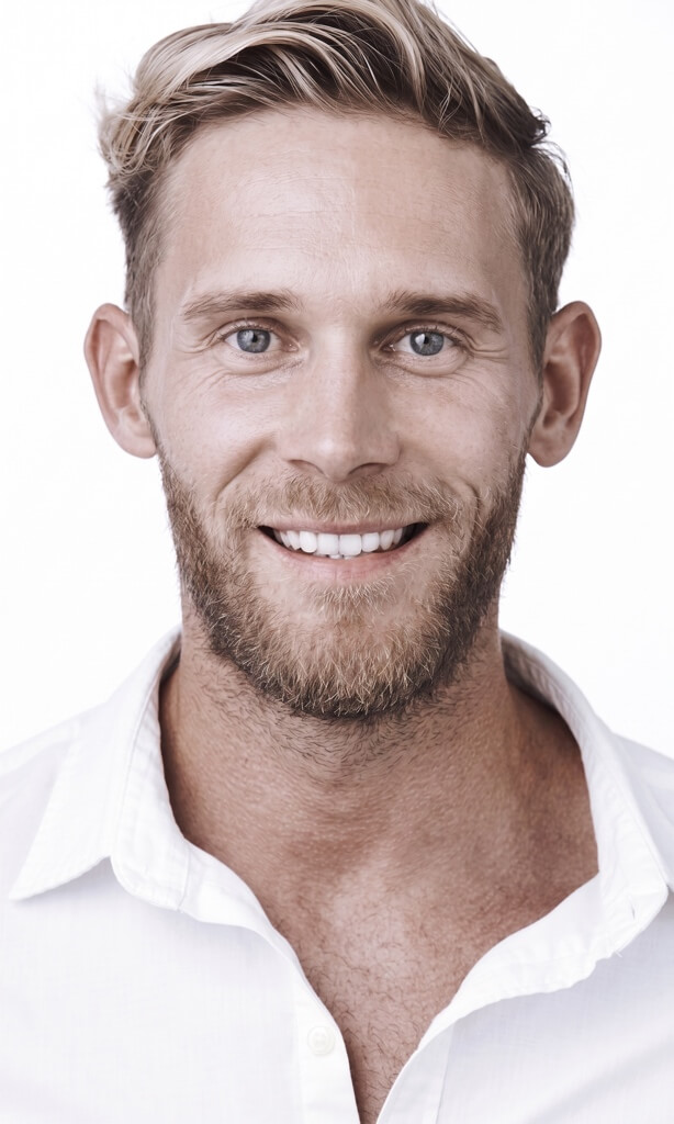 Smiling man with a beard and white shirt